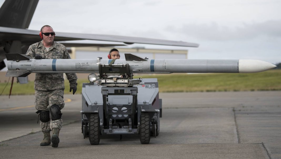 On July 15, 2018, at Joint Base Elmendorf-Richardson in Alaska, U.S. Air Force Tech. Sgt. Joey Lavalley, a weapons load crew chief in the 477th Aircraft Maintenance Squadron, guided the Air Intercept Missile-120 Advanced Medium Air-to-Air Missile to the munitions lift truck after completing F-22 Raptor weapons load training.