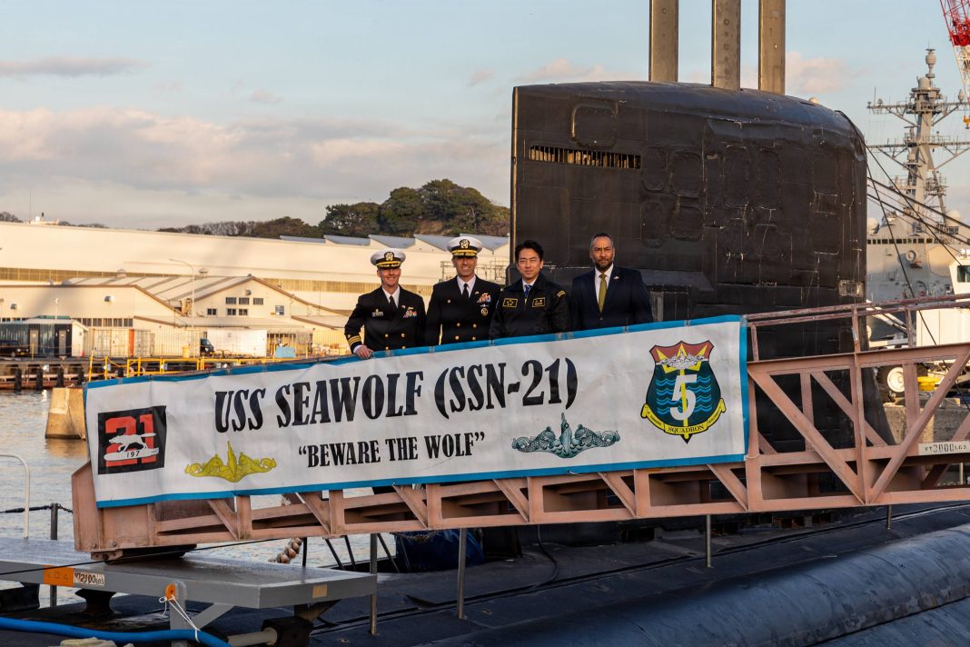 YOKOSUKA, Japan (Dec. 19, 2025) – From left, Cmdr. Douglas Hagenbuch, commanding officer of Seawolf-class fast-attack submarine USS Seawolf (SSN 21), Rear Adm. Lincoln Reifsteck, commander, Submarine Group 7, Japan’s Minister of Defense Shinjiro Koizumi, and Chargé d’Affaires Aaron Snipe of the U.S. Embassy in Japan pose for a photo prior to a tour while the submarine is on a scheduled port visit at Fleet Activities Yokosuka, Dec. 19, 2025. Seawolf, homeported in Silverdale, Washington, and assigned to Submarine Development Squadron 5, is conducting routine operations in the U.S. 7th Fleet area of operations